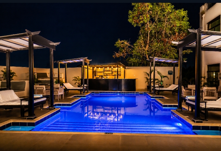 Summerset rooftop pool illuminated at night — Abuja
