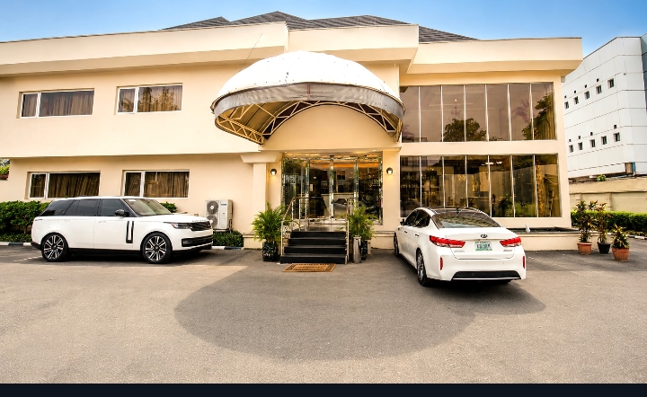Summerset hotel exterior with luxury vehicles